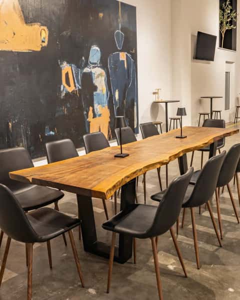 Private dining and event space at Hardwood Bar & Smokery in San Francisco featuring a handcrafted communal wood table, modern seating, and an industrial-chic atmosphere for meetings, celebrations, and group gatherings