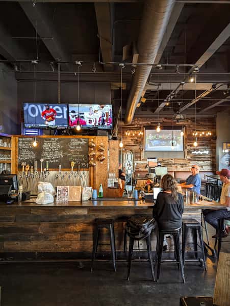 Warm and welcoming bar area at Hardwood Bar & Smokery with rustic wood finishes, glowing string lights, and Bay Area hospitality in San Francisco