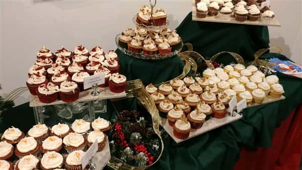 large dessert station with v arious cupcakes on display