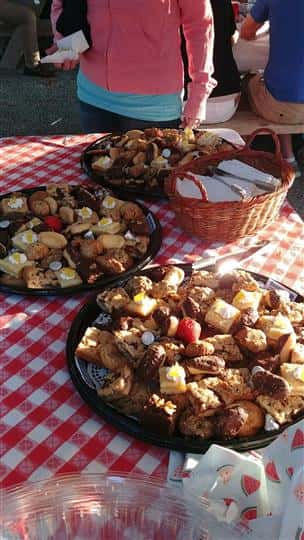 three large plates on a table with various cookies