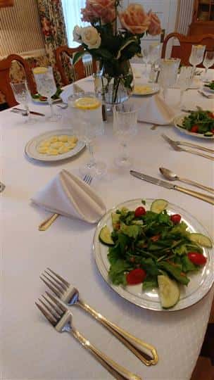 table setup with plates, silverware and napkins