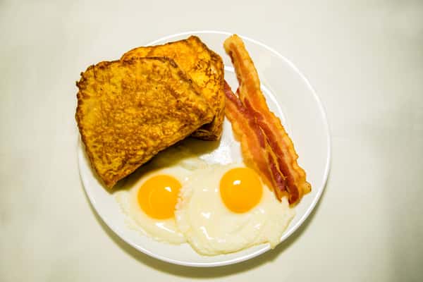 2 slices of French toast (white, wheat, rye, vienna, sweet bread) or 2 pancakes w/2 eggs and choice of bacon, ham, sausage