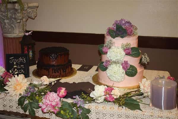 a two-tiered chocolate cake and a three-tiered pink cake