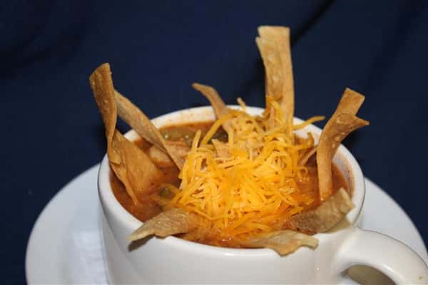 chili in a cup with cheese and chips