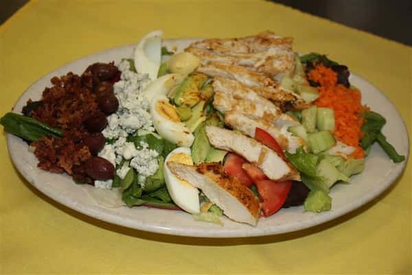 salad with grilled chicken, eggs, bleu cheese and various vegetables