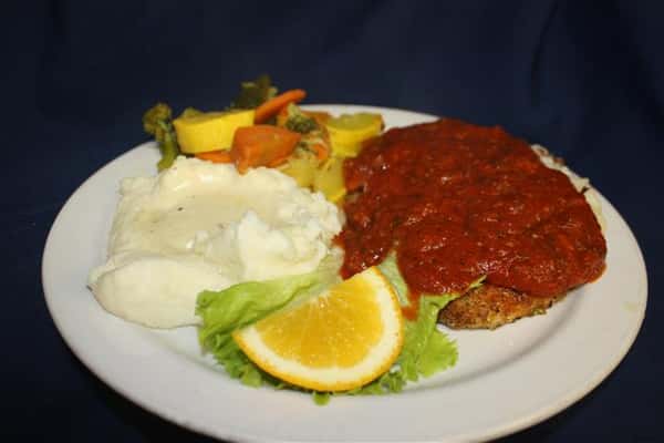 chicken parmesan covered in marinara sauce, with a side of mashed potatoes and sauteed vegetables