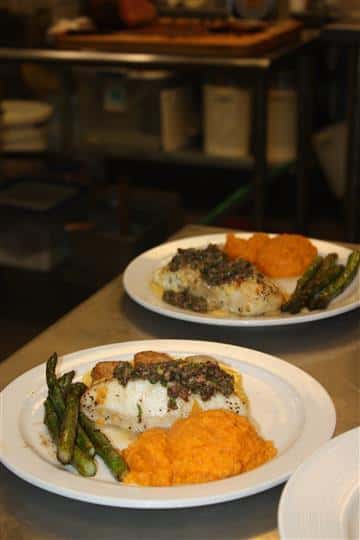 two plates of fish served with asparagus and sweet potatoes