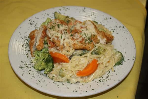 pasta in a cream sauce with chicken, broccoli and carrots