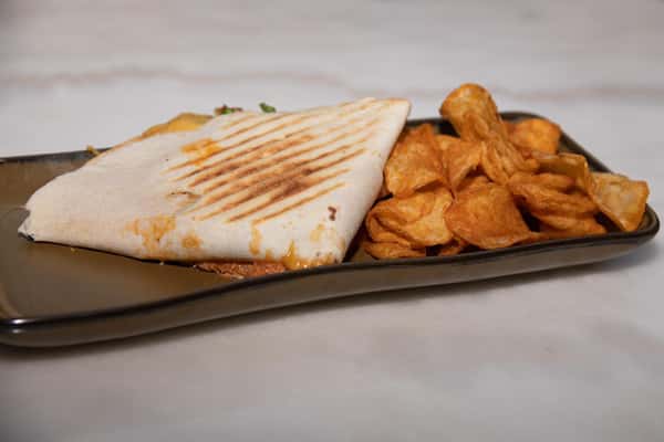 grilled panini with a side of chips