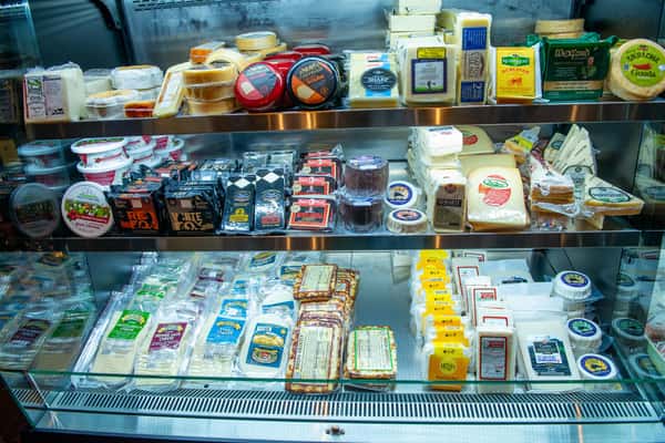 assortment of cheese's in a display case