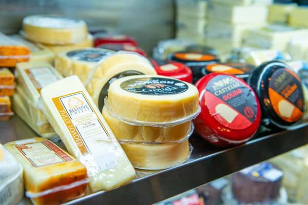 assortment of cheese's in a dispay case