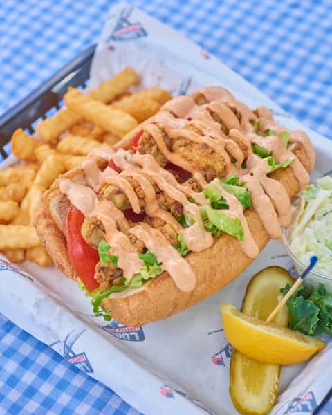 You’re going to need both hands for this one! 😋👏 Enjoy our Po' Boy served with crispy shrimp piled high and ready for your next craving. 🍤 Both locations are currently open!