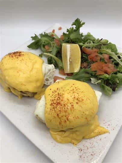 eggs benedict with a side salad