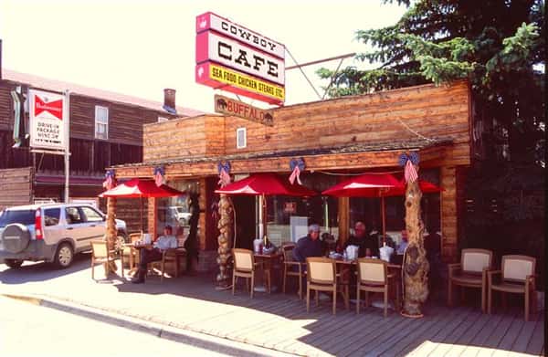 Outdoor shot of the front side of the Restaurant, with people sitting at the tables