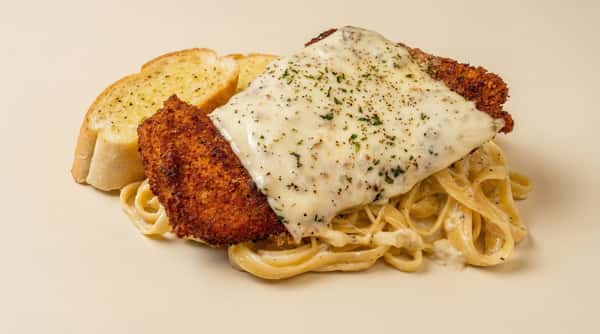 chicken parmesan with melted mozzarella over fettuccine alfredo served with garlic bread