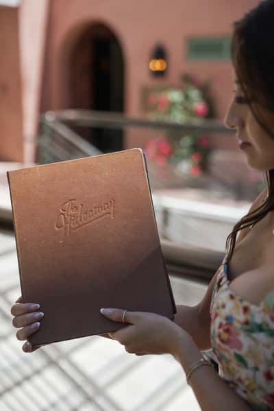 host holding a menu