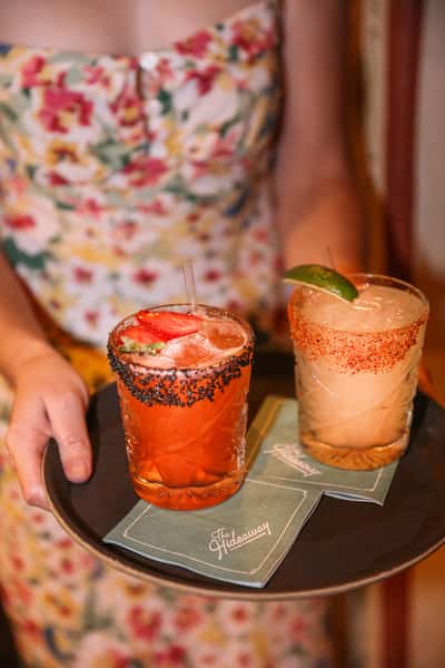 server holding 2 margaritas