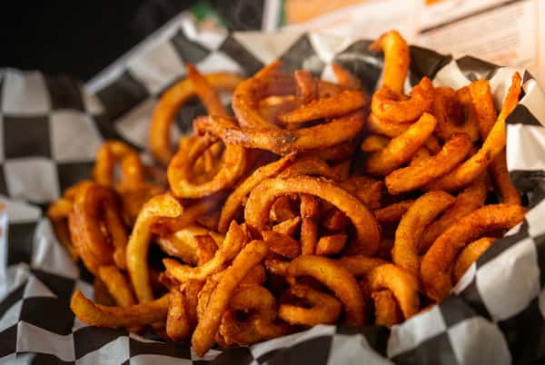 Crispy curly fries and golden fried shrimp served with zesty dipping sauce at The Upper Deck in Mount Airy, Maryland, a casual sports bar known for pub-style seafood and appetizers.