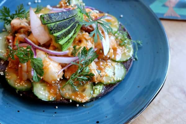 Tostada de Campechana with fresh seafood, avocado and colorful garnishes, a signature starter at Zaranda Houston