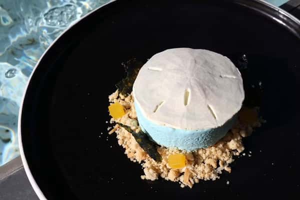 Dólar de Arena, a signature sand dollar dessert with delicate flavors from the pastry menu at Zaranda Houston