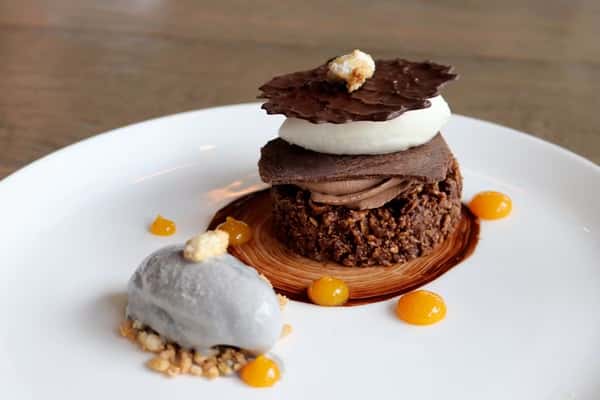 Galleta de Macadamia, a golden macadamia nut cookie dessert from the pastry menu at Zaranda Houston