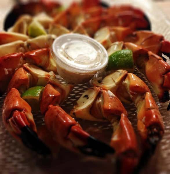 assortment of crab claws with a side of dipping sauce