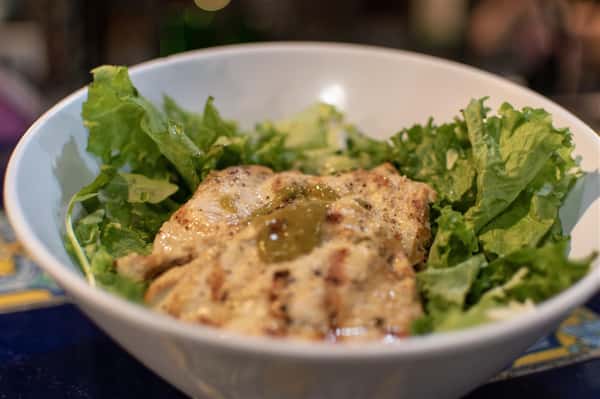 caesar sald topped with grilled chicken