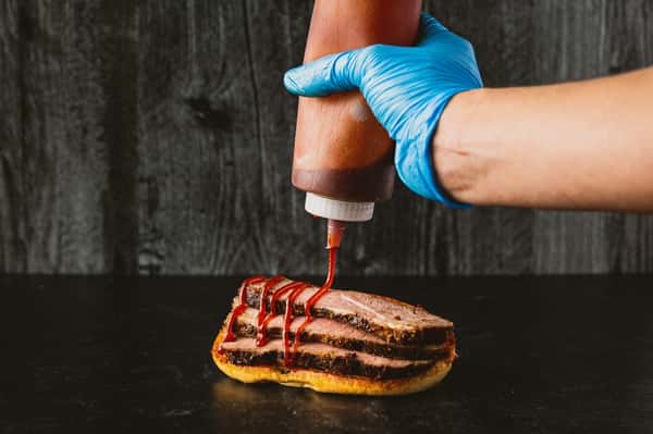 employee prepping sandwich