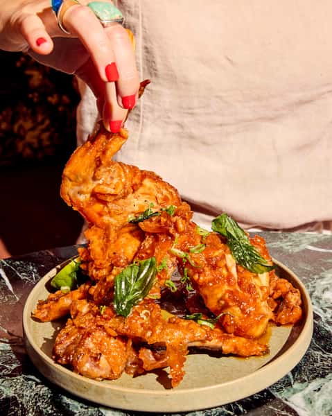 Ayam Penyet wings are crispy, smashed, and served with green sambal