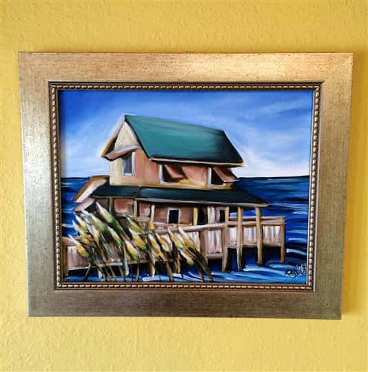 Local art of a little house on the water