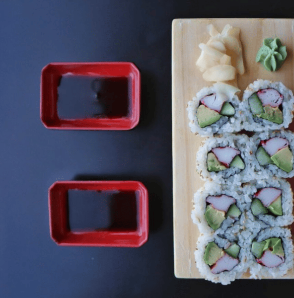 california roll with two sides of soy sauce