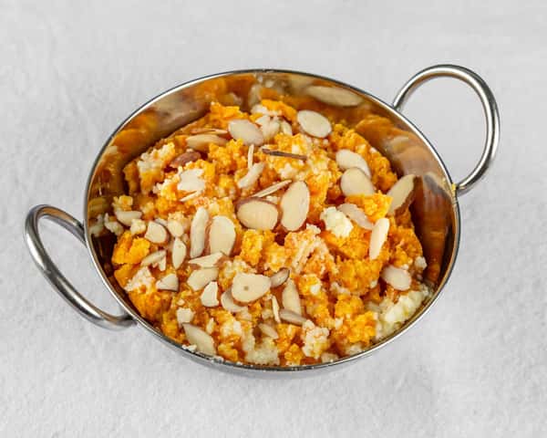 Bowl of food topped with sliced almonds