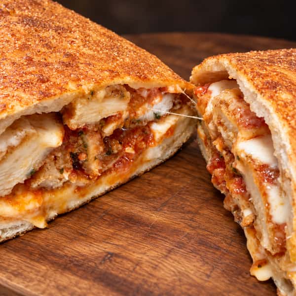 Close-up pizza on a warm wooden board