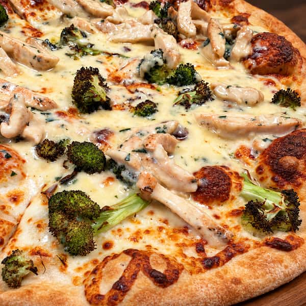 Appetizing pizza on a warm wooden board