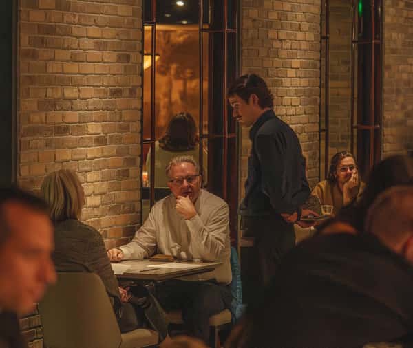 Guests listening to server menu descriptions