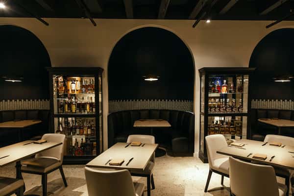 dark booths and dining tables at Repeal in salt lake city