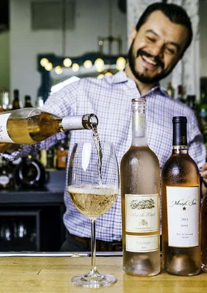 man pouring drinks