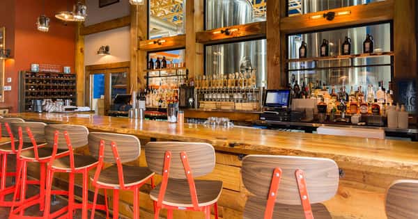 big oyster bar area with wooden bar stools