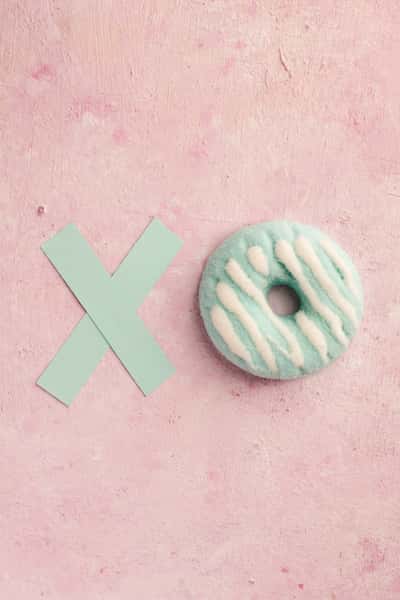 flat lay glazed doughnut with letter x