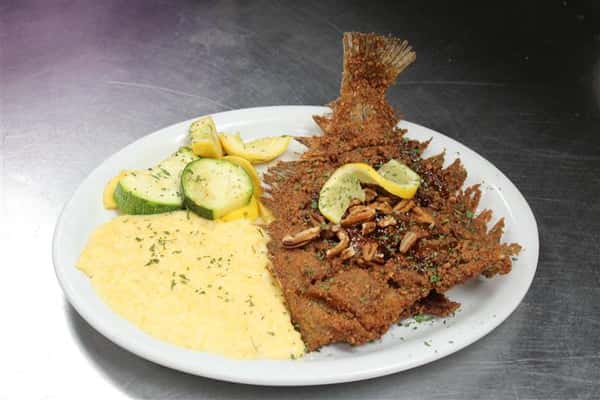 fried fish with grits and vegetables