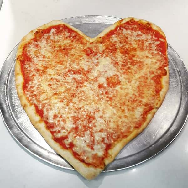heart shaped cheese pizza on a tray