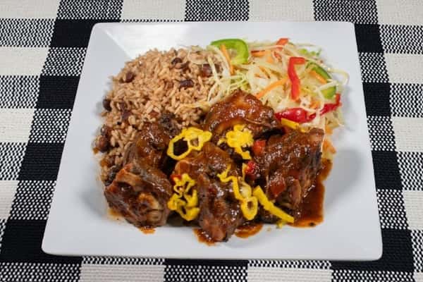 Jerk chicken served with a salad and rice