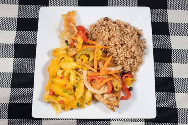 Escovitch Snapper served with size and topped with sliced vegetables