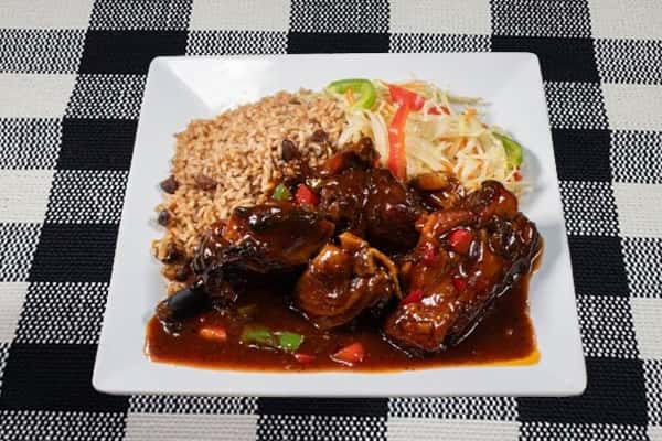 Barbeque Jerk Chicken served with a salad and rice
