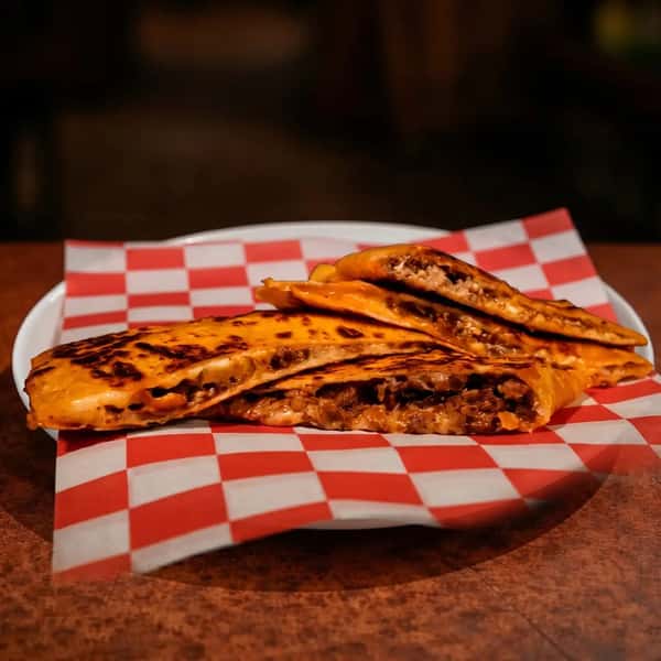grilled quesadilla stuffed with seasoned smash beef and melted cheese with crispy edges