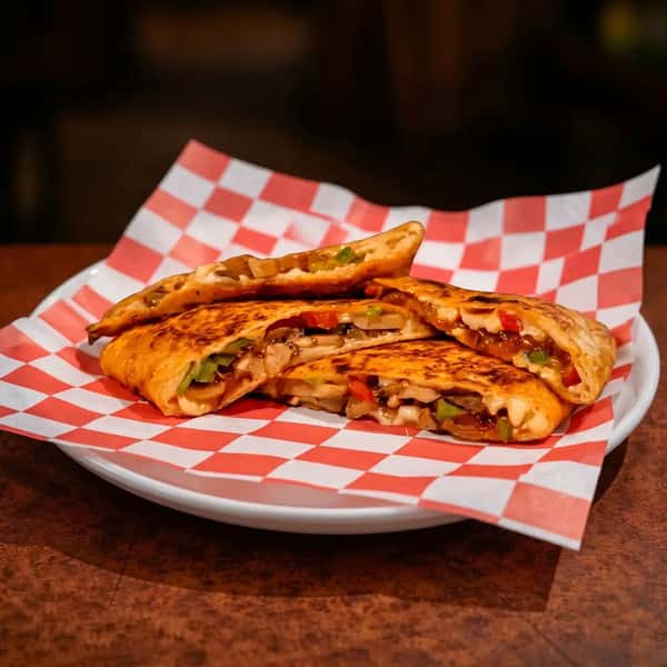 grilled quesadilla with sautéed fajita vegetables and melted cheese in a crispy tortilla