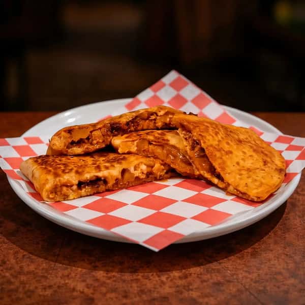 grilled quesadilla filled with BBQ chicken and melted cheese served on a checkered tray