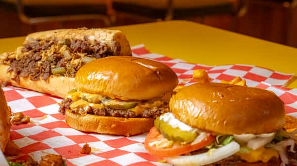 classic cheeseburgers with lettuce, pickles, and melted cheese served on toasted buns