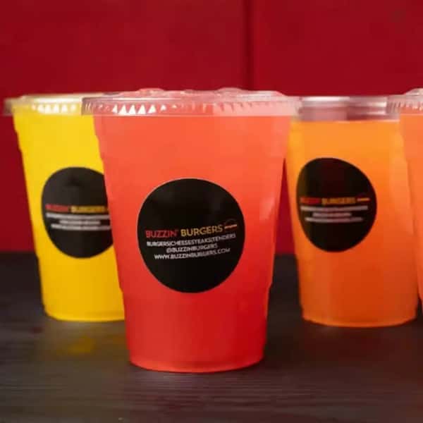 colorful fruit lemonades served in plastic cups with vibrant flavors on display