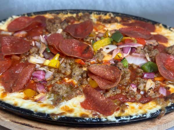 Pizza topped with meat slices and vegetables